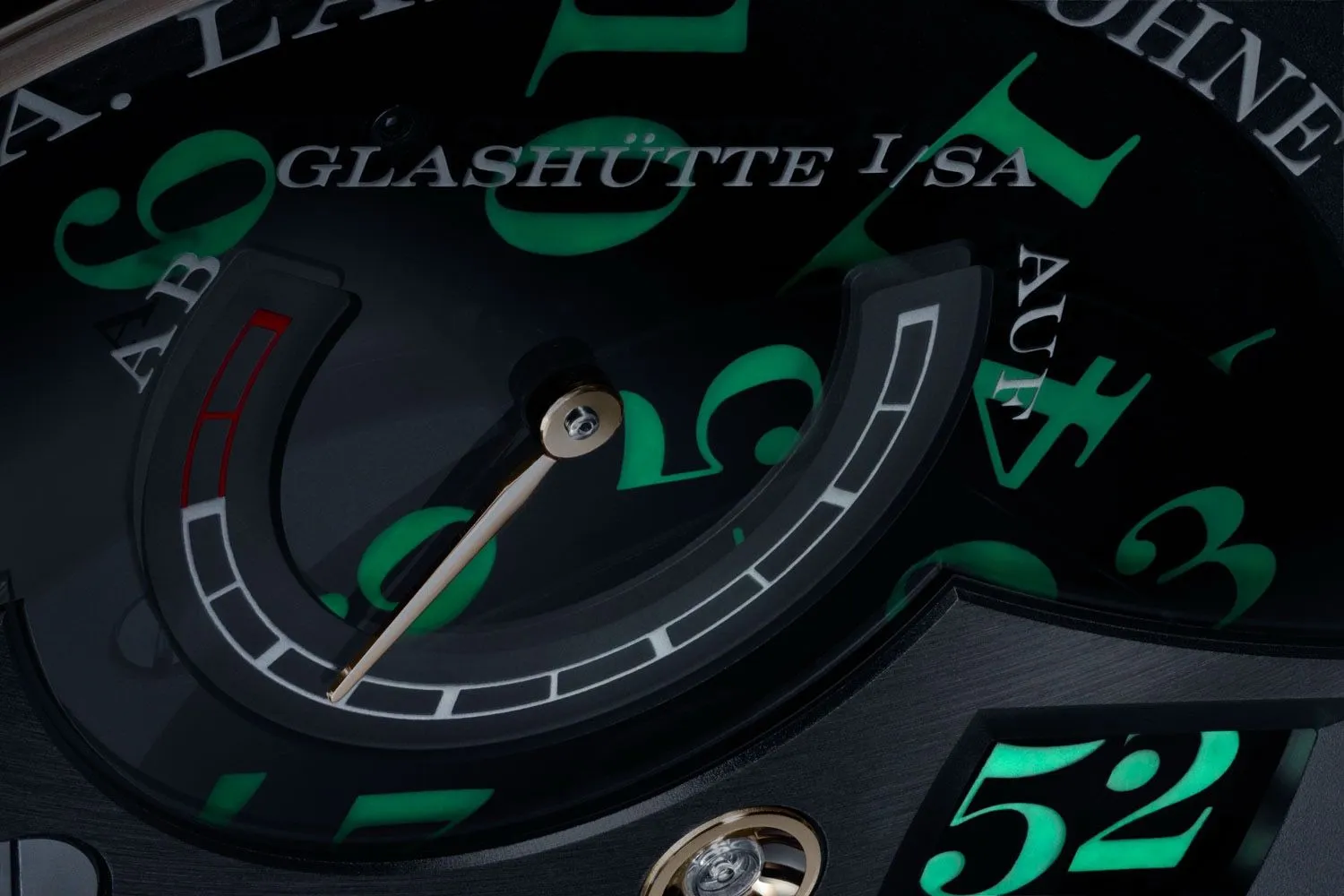 Close-up of a sculptural luxury watch movement with emerald lume